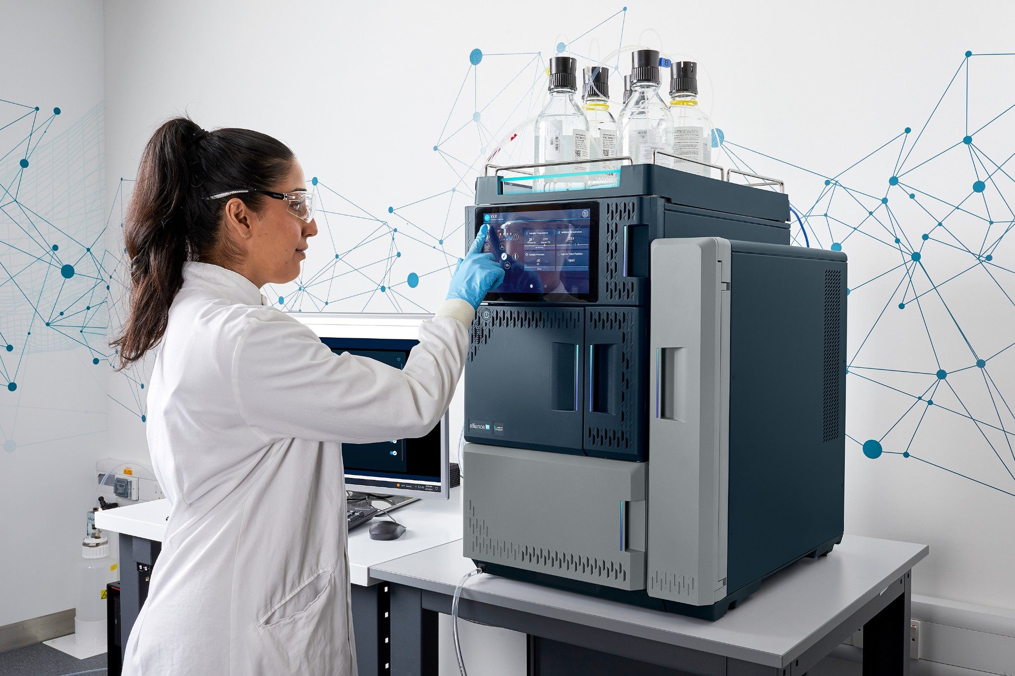 Laboratory technician working with Alliance iS