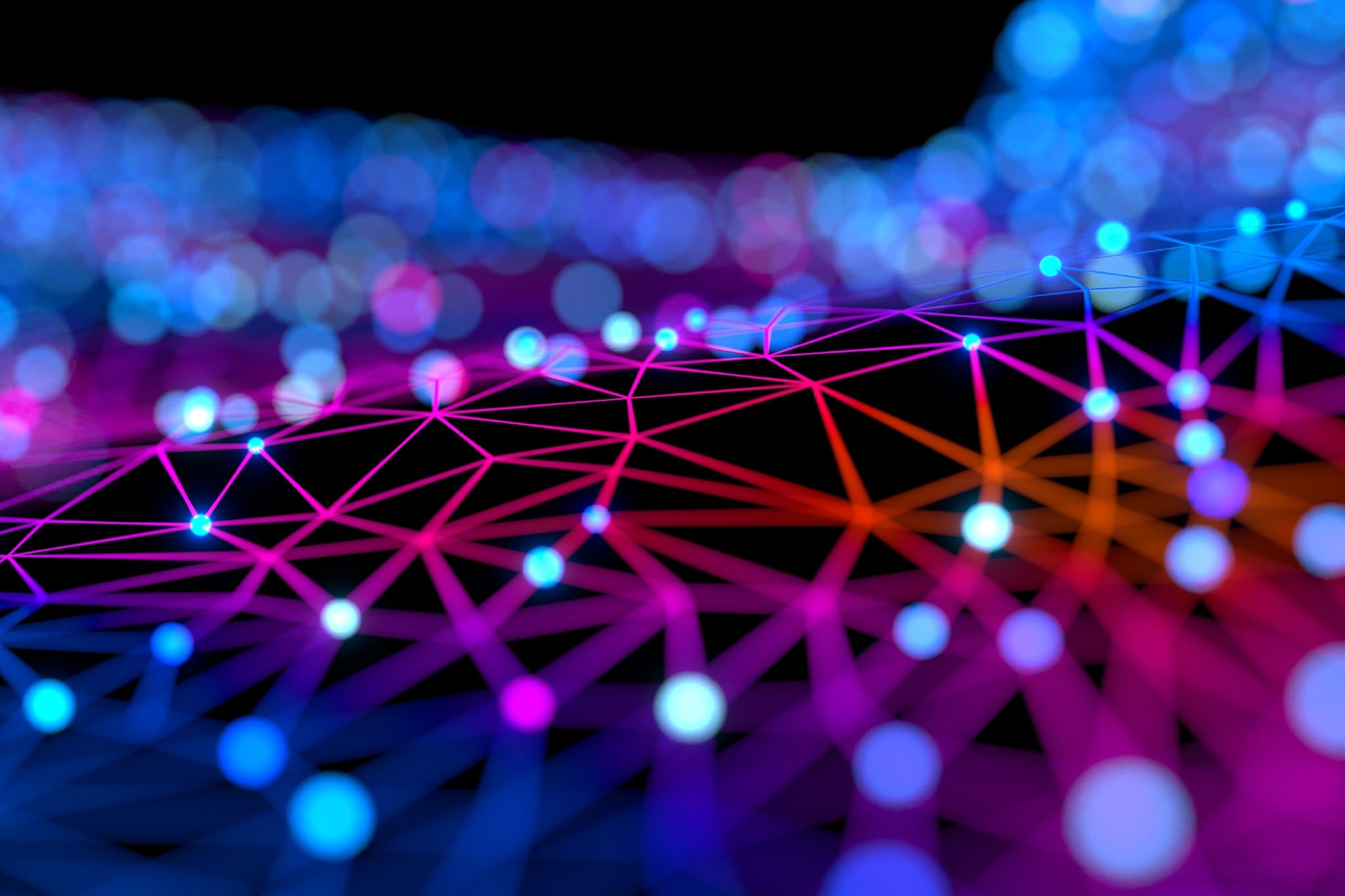 A colorful connection pattern on a black background with some in focused and some in bokeh style