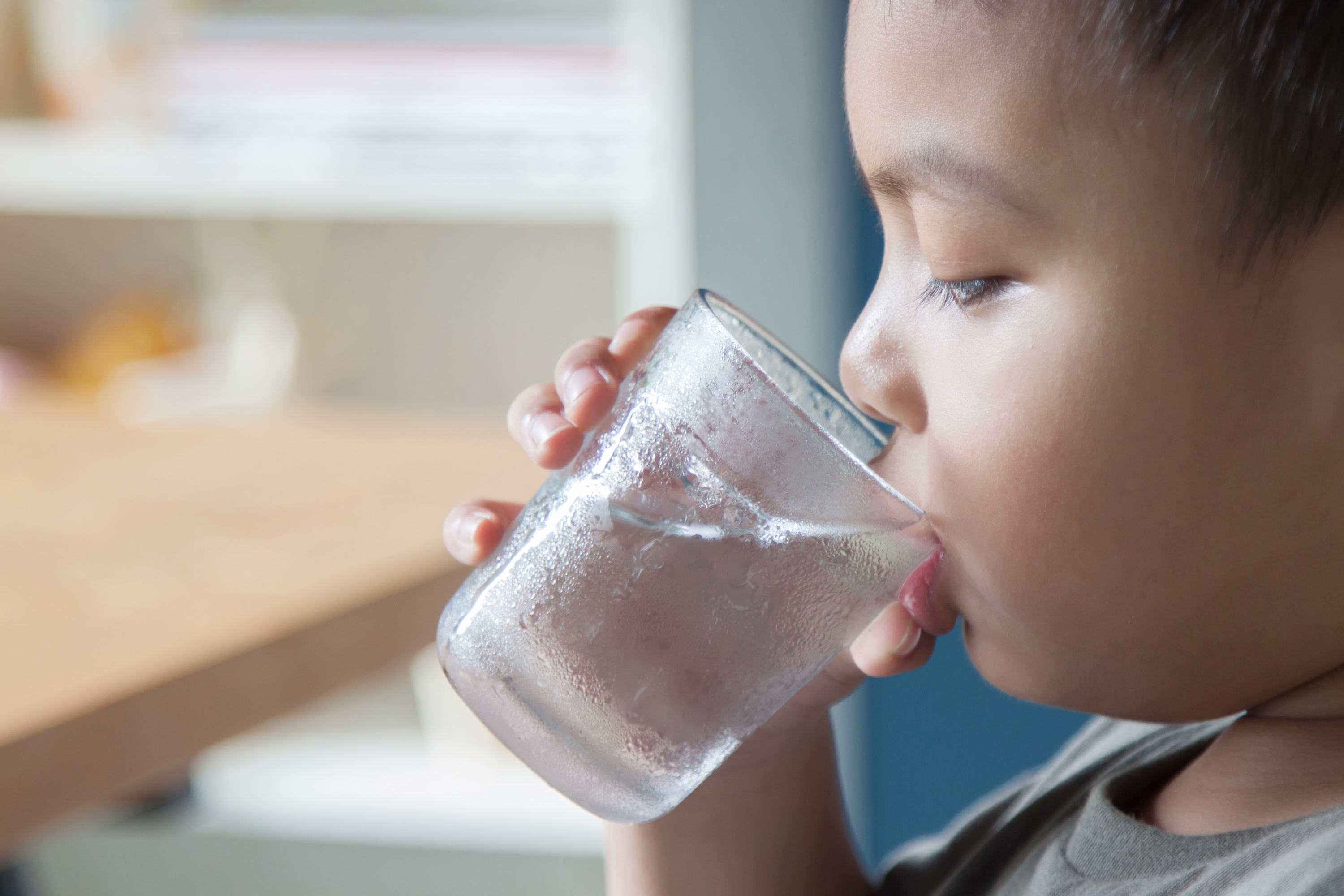 Child drinking water from glass