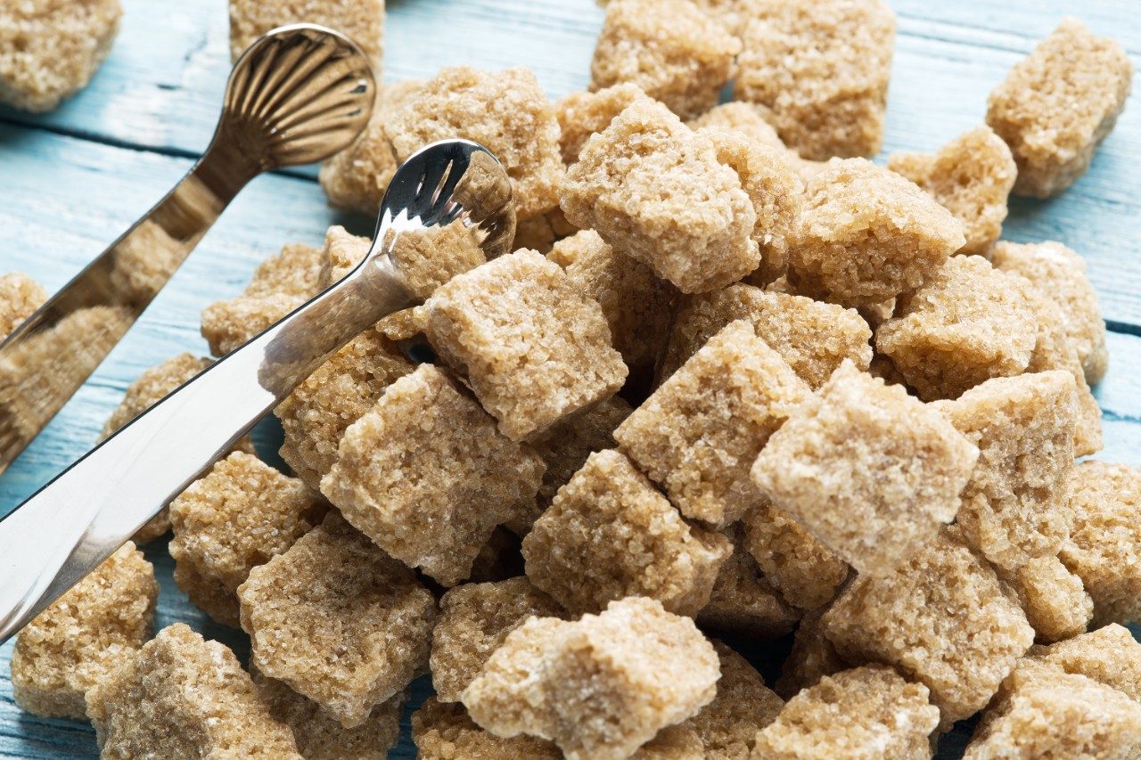 Cubes of cane sugar on wooden table