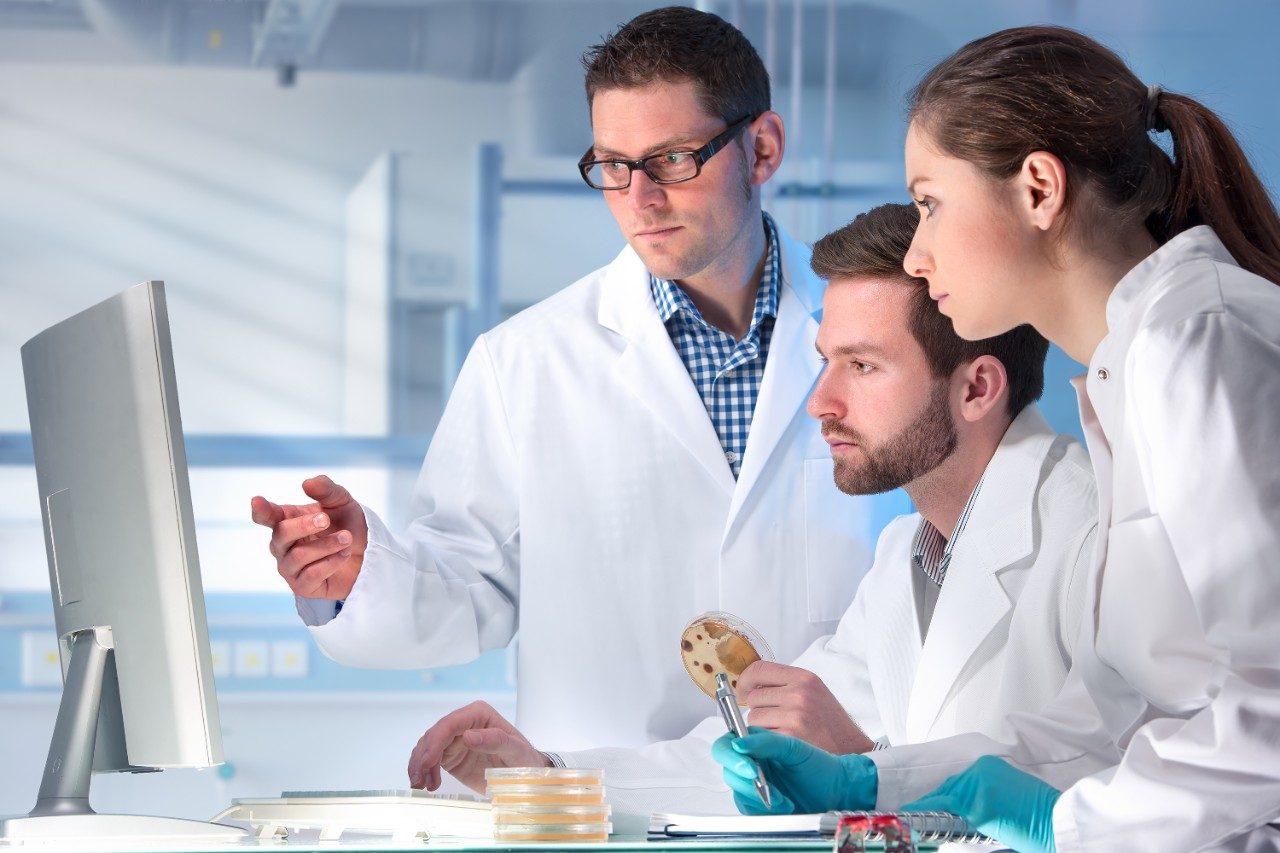 Scientists in lab with petri dish