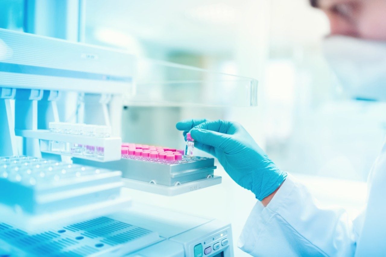 Scientist holding sample in sample prep lab