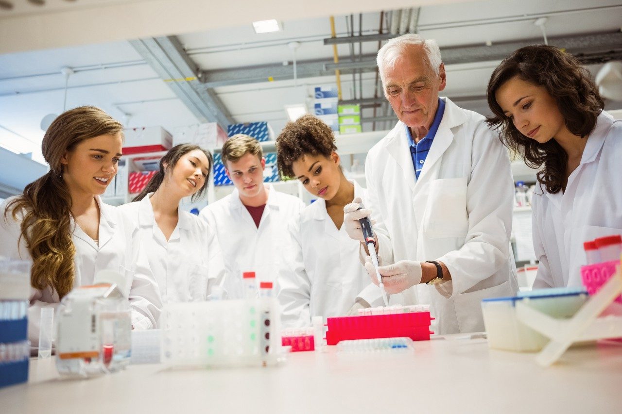 Students watching professor in laboratory